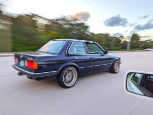 Driving picture of an E30 with an M62 engine swap.