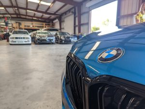 BMW M2 and M3 in the background inside the shop at Eurospec Autowerks.