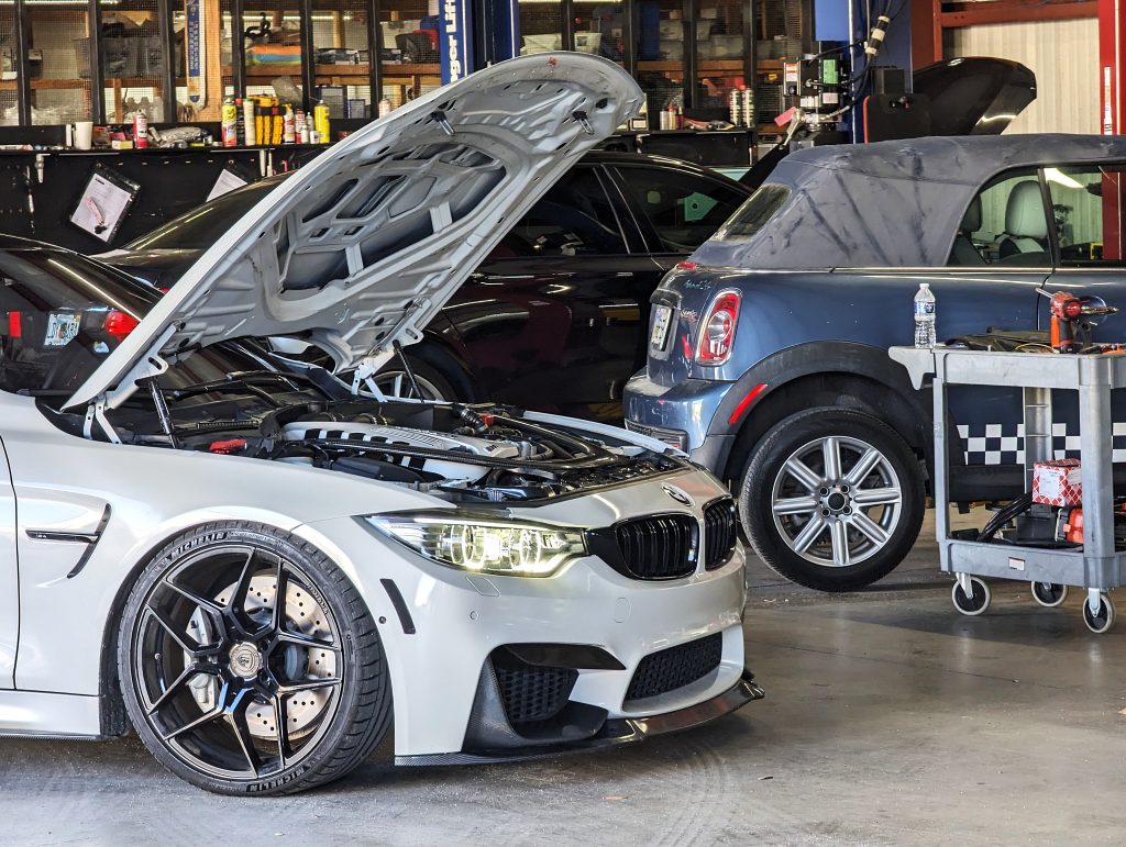 BMW M4 with its hood open in the shop at Eurospec Autowerks.