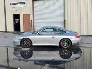 Porsche 996 911 4S parked in a puddle outside of Eurospec Autowerks.