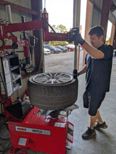 Older low profile Porsche tire being removed.