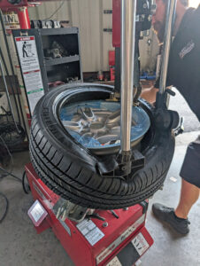 BMW Michelin tire being mounted on a brand new wheel.