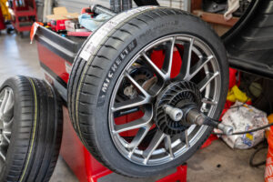 Michelin tire getting balanced on brand new Enkei wheel.